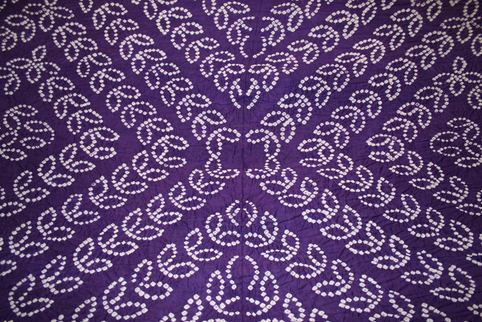 A bandhani print opened out, showing the tie-dye dot pattern