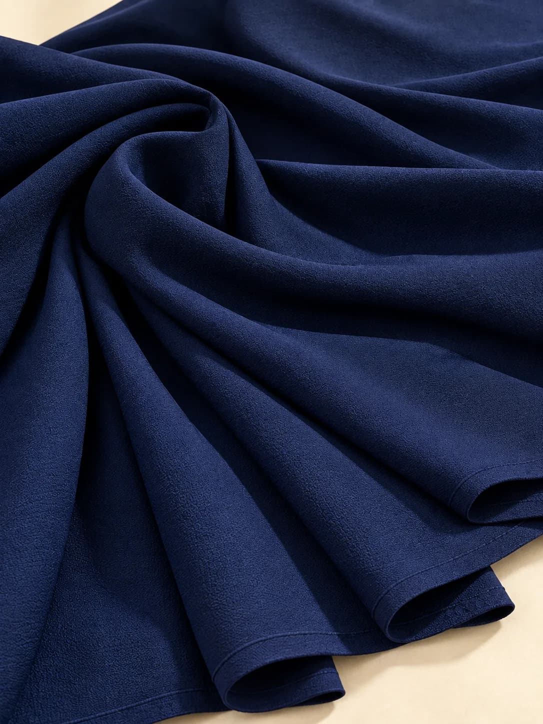 Navy crepe saree fabric showing its fine pebbled texture and matte finish