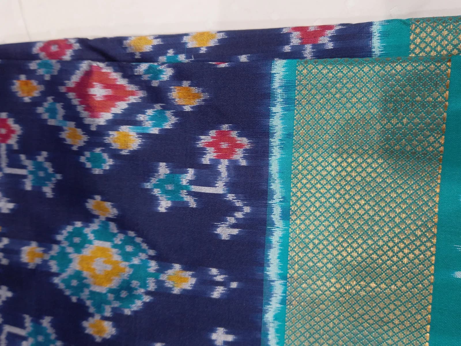 A Pochampally ikat saree with a geometric pattern and gold zari border