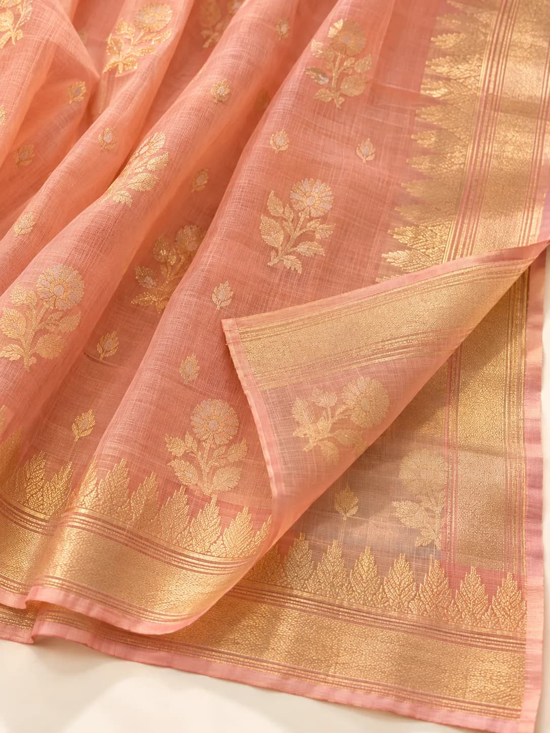 A peach Uppada silk saree with fine jamdani-style gold zari motifs