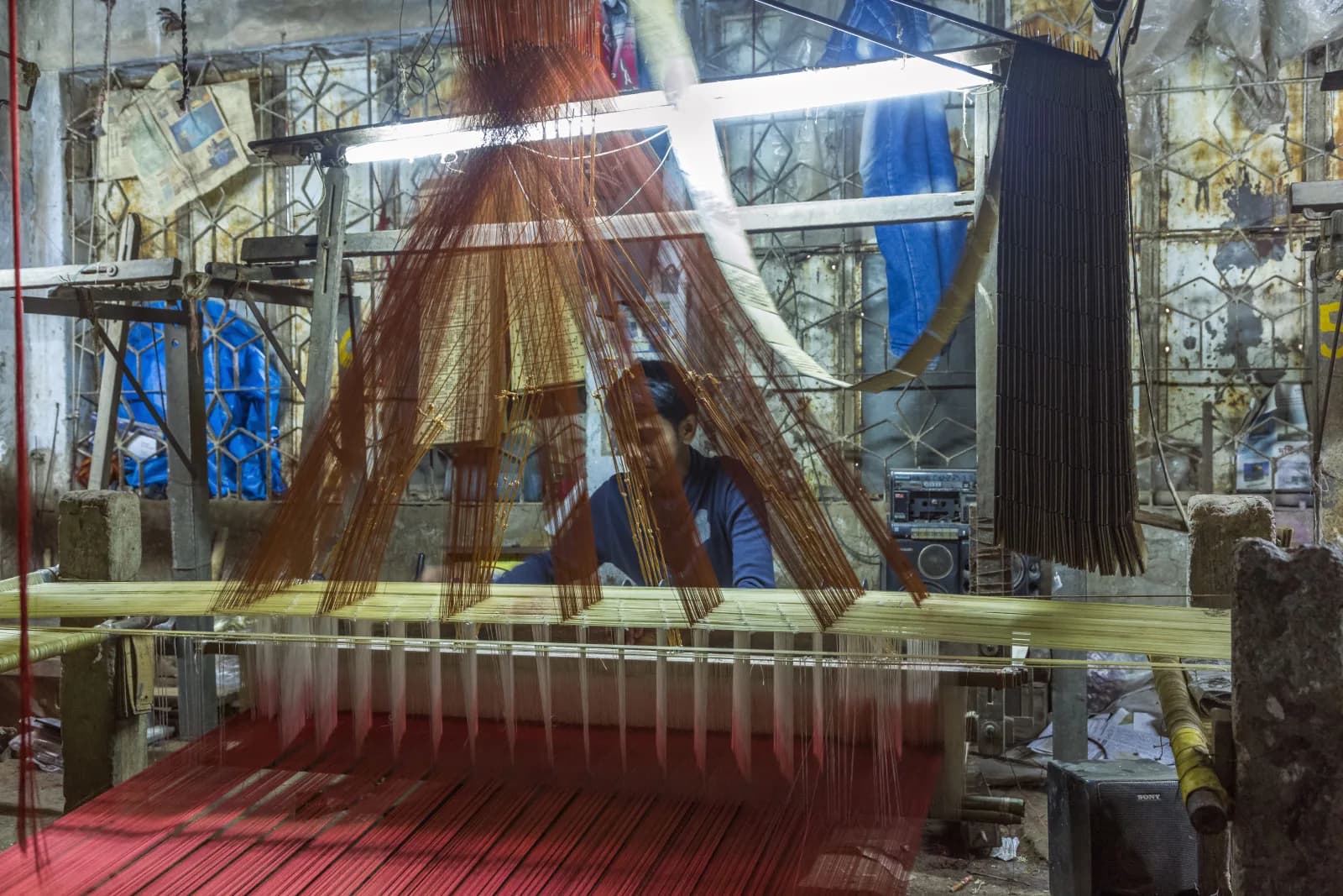 A weaver at a handloom producing a Banarasi-style silk brocade, Mirpur Benarashi Palli, Dhaka